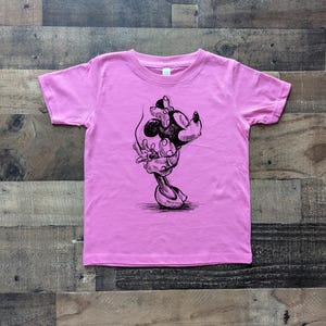 May include: Pink t-shirt with a black and white illustration of a cartoon mouse with a bow.