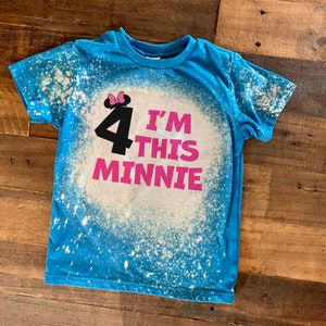 May include: A blue t-shirt with a white bleach splattered design. The shirt has a pink graphic that says "I'm 4 This Minnie" with a black silhouette of Minnie Mouse wearing a pink bow.