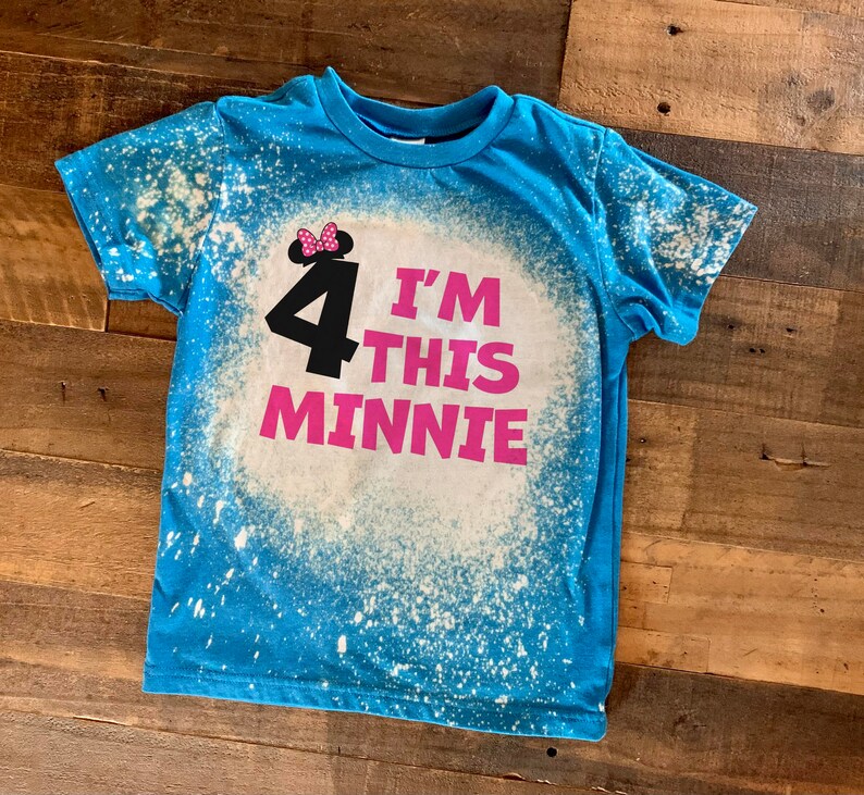 May include: A blue t-shirt with a white bleach splattered design. The shirt has a pink graphic that says "I'm 4 This Minnie" with a black silhouette of Minnie Mouse wearing a pink bow.
