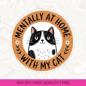 May include: A round orange sticker with the text "Mentally at home with my cat" in black. A black and white cartoon cat with a happy expression is in the center of the sticker.