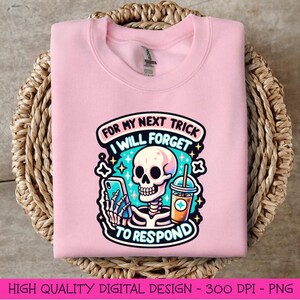 May include: Pink sweatshirt with a graphic of a skeleton holding a phone and a drink. The text reads "For my next trick I will forget to respond".