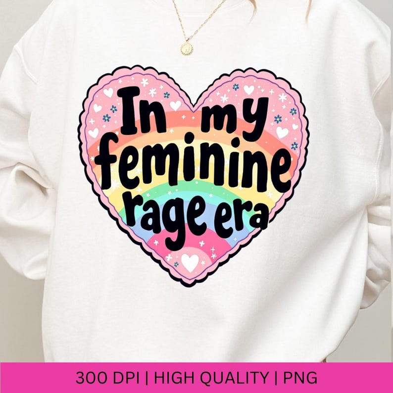 May include: A white sweatshirt with a rainbow heart design that says "In my feminine rage era".