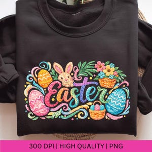 May include: Black sweatshirt with a colorful Easter design. The design includes the word "Easter" in a script font, along with Easter eggs, a bunny, flowers, and decorative swirls. The image also includes the text "300 DPI | HIGH QUALITY | PNG".