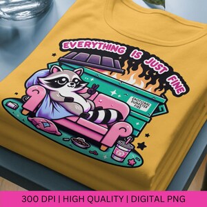 May include: A yellow t-shirt with a graphic of a raccoon sitting on a pink couch in front of a green dumpster on fire. The text "Everything is just fine" is above the dumpster and "Emotional Dumpster Fire" is on the dumpster.