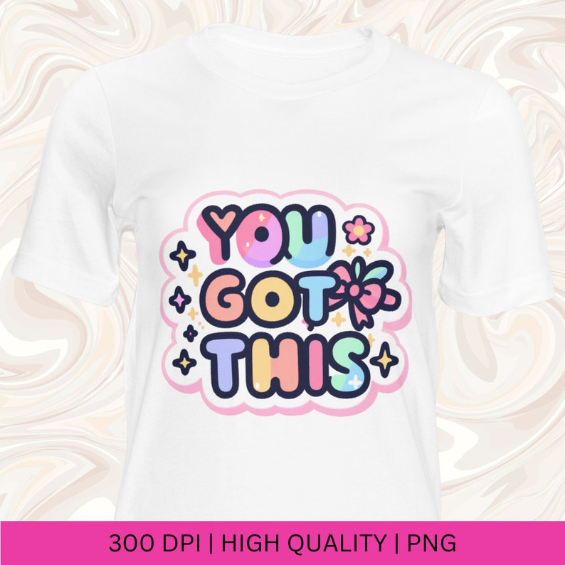 May include: A white t-shirt with a colorful graphic that says "YOU GOT THIS" in a cartoon font with stars and a bow.