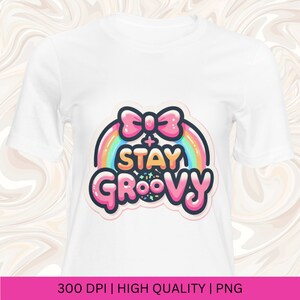 May include: White t-shirt with a pink bow and rainbow graphic that says "Stay Groovy".