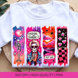 May include: A white sweatshirt with a graphic design featuring four colorful panels. The panels depict a skeleton, a skull with sunglasses, a sunset scene, and a checkered pattern with hearts and stars. The text "Everyone was thinking it" and "I just said it" are included in the design.