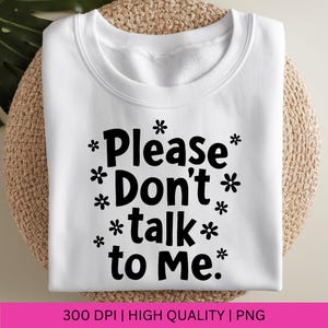 Puede incluir: Sudadera blanca con texto negro que dice "*Please Don't *talk* to Me.*" con peque&ntilde;os s&iacute;mbolos de flores alrededor del texto.
