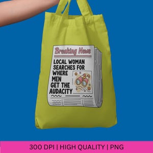 May include: A lime green tote bag with a newspaper-style graphic. The graphic reads "Breaking News" and "Local Woman Searches For Where Men Get The Audacity." The design includes binoculars and stars. The bag has two handles.