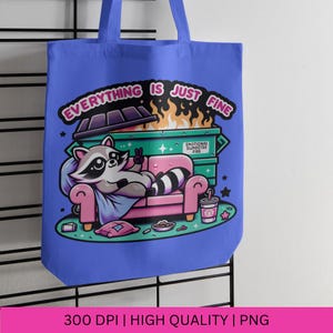 May include: A blue tote bag with a cartoon raccoon sitting on a couch in front of a dumpster fire. The text on the bag reads "Everything is just fine." and "Emotional Dumpster Fire."