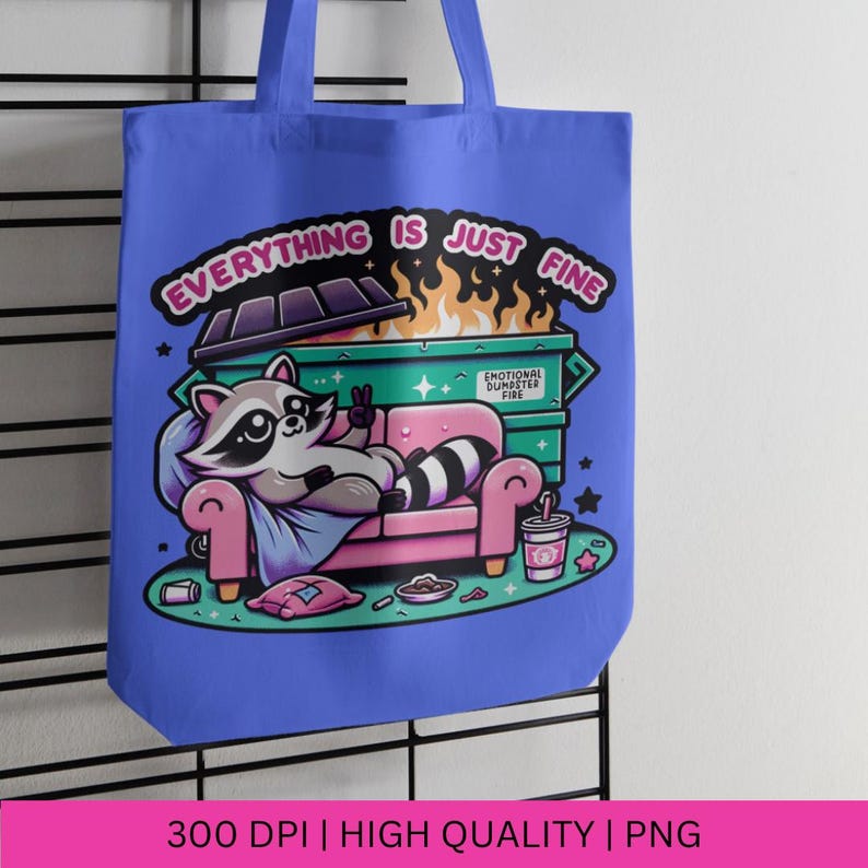 May include: A blue tote bag with a cartoon raccoon sitting on a couch in front of a dumpster fire. The text on the bag reads "Everything is just fine." and "Emotional Dumpster Fire."