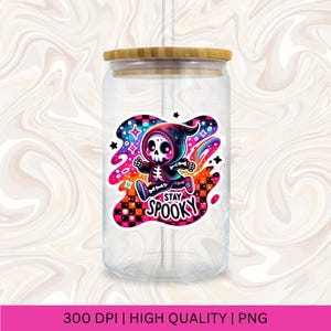 May include: A clear glass jar with a bamboo lid and a straw. The jar has a colourful sticker with a cartoon skeleton wearing a black hooded cloak and the text "Stay Spooky".