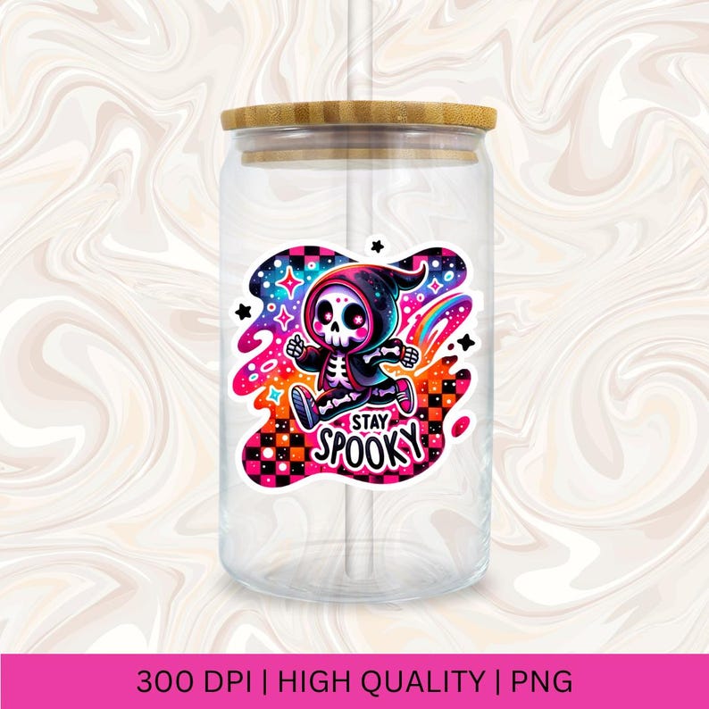 May include: A clear glass jar with a bamboo lid and a straw. The jar has a colourful sticker with a cartoon skeleton wearing a black hooded cloak and the text "Stay Spooky".
