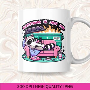 May include: White ceramic mug with a cartoon raccoon sitting on a pink couch in front of a green dumpster with flames. The text "Everything is just fine" is written in a colorful font around the dumpster. The dumpster has the text "Emotional Dumpster Fire" on the side.
