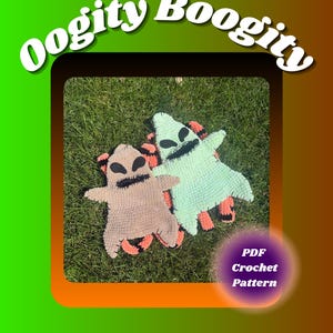 May include: Two flat, crocheted figures with black stitched eyes and mouths, one in light brown and one in pale green, both featuring orange and black striped limbs. The text Oogity Boogity appears at the top, with PDF Crochet Pattern below.