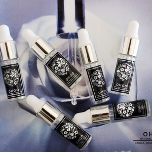 May include: Six clear glass dropper bottles with silver collars and white rubber bulbs. Each bottle features a black rectangular label with white floral illustrations and the text OHOO and www.ohoo.com.au printed in white.
