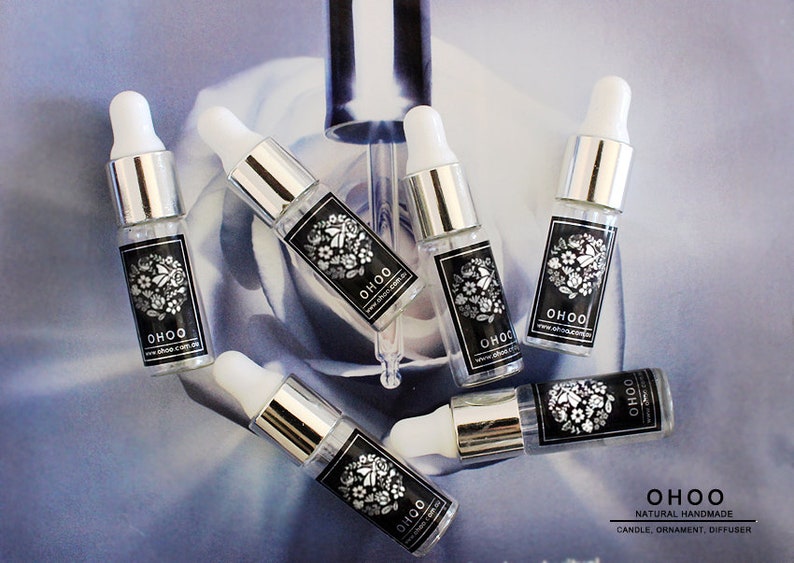 May include: Six clear glass dropper bottles with silver collars and white rubber bulbs. Each bottle features a black rectangular label with white floral illustrations and the text OHOO and www.ohoo.com.au printed in white.
