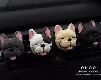 May include: Four French bulldog head ornaments in dark gray, white and black, cream, and black colors, each with pink ears and a tongue sticking out. The text O H O O NATURAL HANDMADE CANDLE, ORNAMENT, DIFFUSER is printed in the bottom right corner.