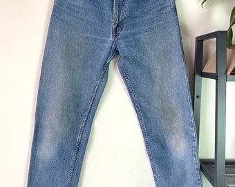 May include: A pair of light blue denim jeans with a straight leg fit.