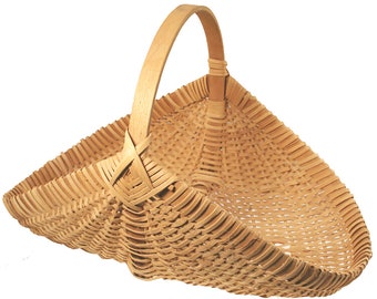 May include: A woven basket with a natural wood finish and a single handle. The basket is made of thin strips of wood that are woven together to create a sturdy and durable container.