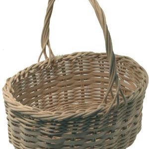 May include: A natural woven wicker basket with a single handle. The basket is oval shaped and has a light brown color.
