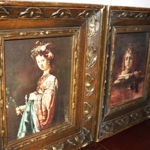 May include: Two framed paintings with ornate wooden frames. The paintings feature portraits of women in period clothing.
