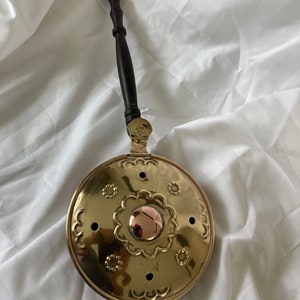 Antique copper bedpan with wooden handle.