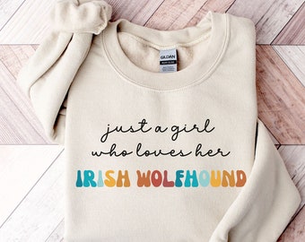 May include: A beige sweatshirt with the text "just a girl who loves her IRISH WOLFHOUND" in rainbow colors.