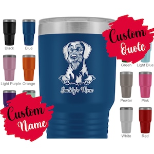 May include: A blue stainless steel tumbler with a white silhouette of a dog breed, the text "Buddy's Mom" and a customizable name and quote. The tumbler is available in a variety of colors.