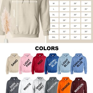 May include: Unisex hooded sweatshirt size chart with measurements in inches.  The chart shows width, length, and sleeve length for sizes S through 5XL.  The sweatshirt is available in 18 colors: Sand, Light Pink, Red, Royal Blue, Light Blue, Carolina Blue, Dark Heather, White, Sport Grey, Charcoal, Orange, Maroon, Purple, Black, Navy, Forest Green, Military Green, and Heather Navy.
