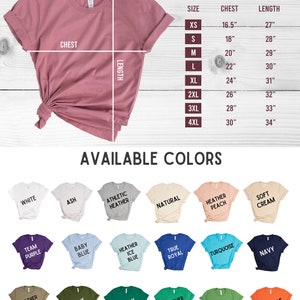 May include: Size chart for t-shirts with measurements in inches for chest and length. Available colors include white, ash, athletic heather, natural, heather peach, soft cream, team purple, baby blue, heather ice blue, true royal, turquoise, navy, heather olive, olive, kelly, heather kelly, leaf, orange, maroon, red, pink, heather mauve, dark grey heather, and black.