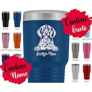 May include: A blue stainless steel tumbler with a silver lid. The tumbler features a white graphic of a German Shorthaired Pointer dog with the text "Buddy's Mom". The tumbler is surrounded by smaller tumblers in various colours.