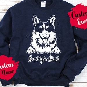 May include: Navy blue sweatshirt with a white graphic of a corgi dog with the text "Buddy's Dad".