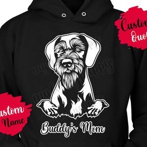 May include: Black hoodie with a white illustration of a dog breed, possibly a Wirehaired Pointing Griffon, with the text "Buddy's Mom" below the image. There are two red text boxes, one with the text "Custom Name" and the other with the text "Custom Quote".