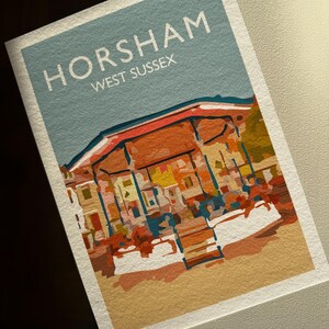 May include: A print depicting a stylized illustration of Horsham, West Sussex. The artwork features a building with a red roof against a light blue sky. The text "HORSHAM WEST SUSSEX" is displayed at the top of the print.