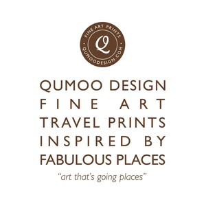 May include: A white background with brown text promoting fine art travel prints. The text reads "QUMOO DESIGN FINE ART TRAVEL PRINTS INSPIRED BY FABULOUS PLACES". A circular logo at the top says "FINE ART PRINTS" and "QUMOODESIGN.COM". The tagline is "art that's going places".