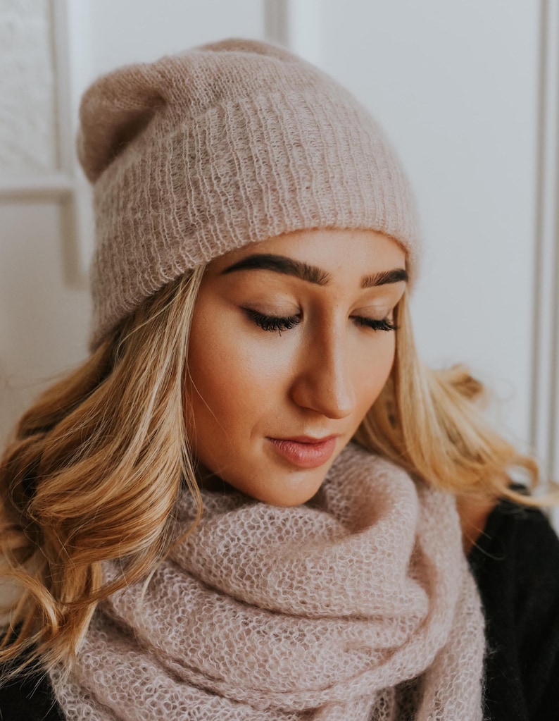 Peut inclure: Un bonnet et une &eacute;charpe assortis en tricot rose p&acirc;le et doux. Le bonnet est ample et pr&eacute;sente une texture c&ocirc;tel&eacute;e. L'&eacute;charpe est longue et s'enroule autour du cou.