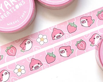 May include: Pink washi tape rolls with a repeating pattern of pink cartoon sharks, strawberries, and white flowers. The tape rolls have the text "KYARI KREATIONS WASHI TAPE" printed on them.