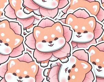 May include: A collection of stickers featuring a cartoon Shiba Inu dog wearing a pink flower. The dog has a light orange body, white eyes, and a pink nose.