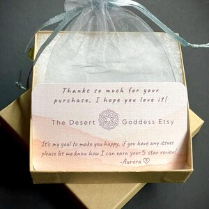May include: A small, brown cardboard box with a light blue organza bag on top. The box contains a thank you card with the text "Thanks so much for your purchase, I hope you love it! The Desert Goddess Etsy It's my goal to make you happy, if you have any issues please let me know how I can earn your 5 star review! -Aurora"
