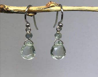 May include: A pair of silver dangle earrings with green and blue gemstone drops.