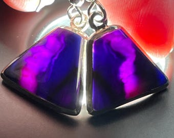 May include: A pair of silver earrings with triangular purple and blue agate stones.
