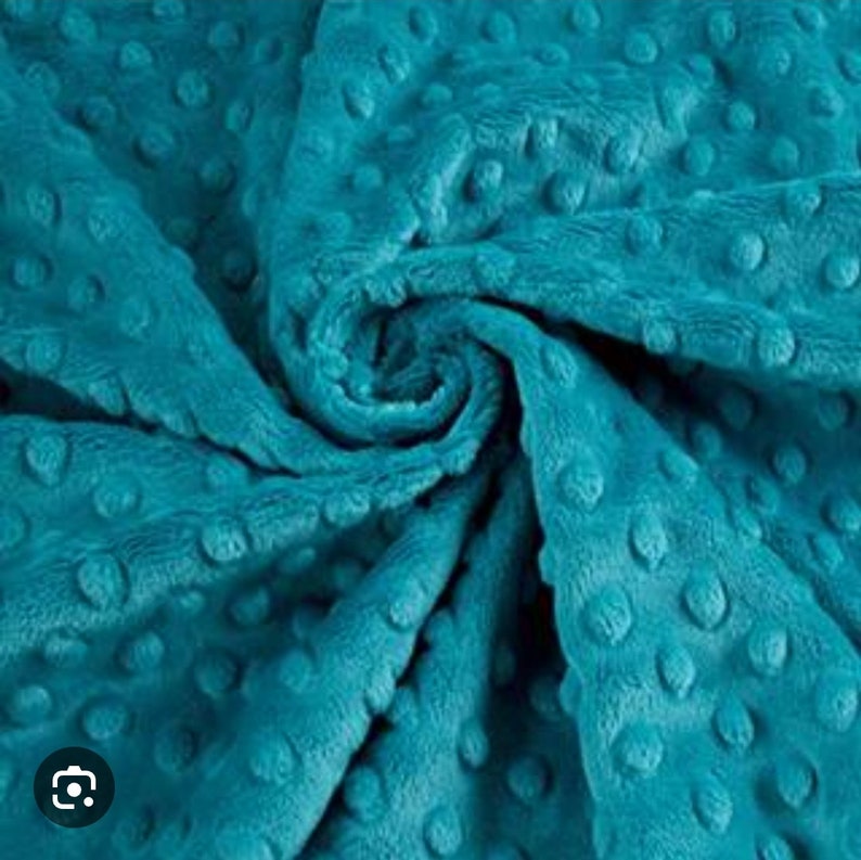 May include: Teal blue minky fabric with a textured dot pattern. The fabric is soft and plush.