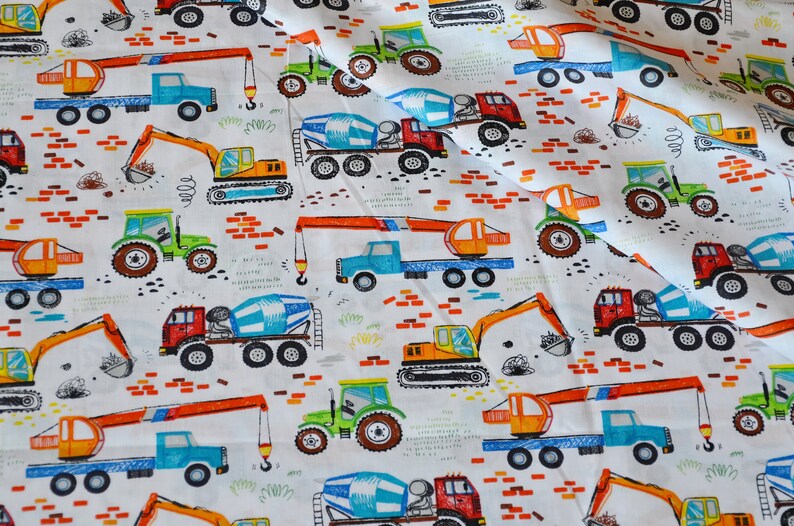 May include: White fabric with a repeating pattern of colorful construction vehicles. The vehicles include a crane, a cement mixer, an excavator, and a tractor. The fabric is perfect for crafting projects, quilting, and sewing.