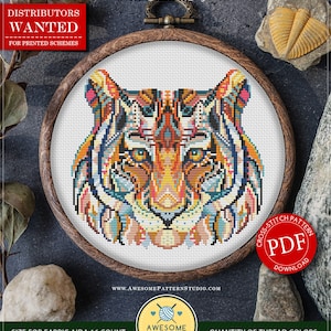 May include: A colorful cross stitch pattern of a tiger's face with a mandala design. The pattern is framed in a wooden hoop and is available as a PDF download. The pattern is 101 stitches wide by 94 stitches high and uses 18 DMC colors.