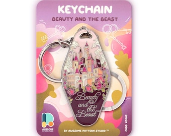 May include: A motel-style keyring featuring a castle illustration with pink and purple accents, surrounded by roses. The keyring is attached to a silver metal ring and displayed on a purple backing card with the text Beauty and the Beast.