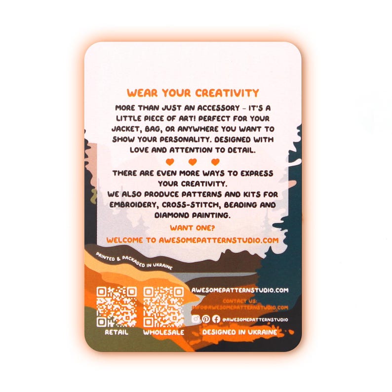 May include: A rectangular card with rounded corners, featuring text in orange and white. The card promotes creativity and accessories for jackets and bags. It also mentions patterns and kits for embroidery, cross-stitch, beading, and diamond painting. The card is designed in Ukraine.