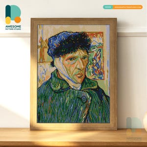 May include: Framed cross-stitch portrait of Vincent van Gogh, featuring his self-portrait with a bandaged ear. The artwork is in a wooden frame and is displayed on a wooden surface. The image is from Awesome Pattern Studio.