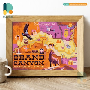 May include: A framed cross-stitch depicting the Grand Canyon National Park. The artwork shows a map with a bird, helicopter, and a bighorn sheep. The text "Welcome to Grand Canyon National Park" is displayed in a bold font. The colour palette includes orange, purple, and yellow.