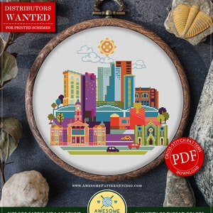May include: A cross-stitch pattern of the Fort Worth skyline in a wooden embroidery hoop. The design features colorful buildings, a sun, and the text "Fort Worth." The pattern is for instant download and includes 18 colors.
